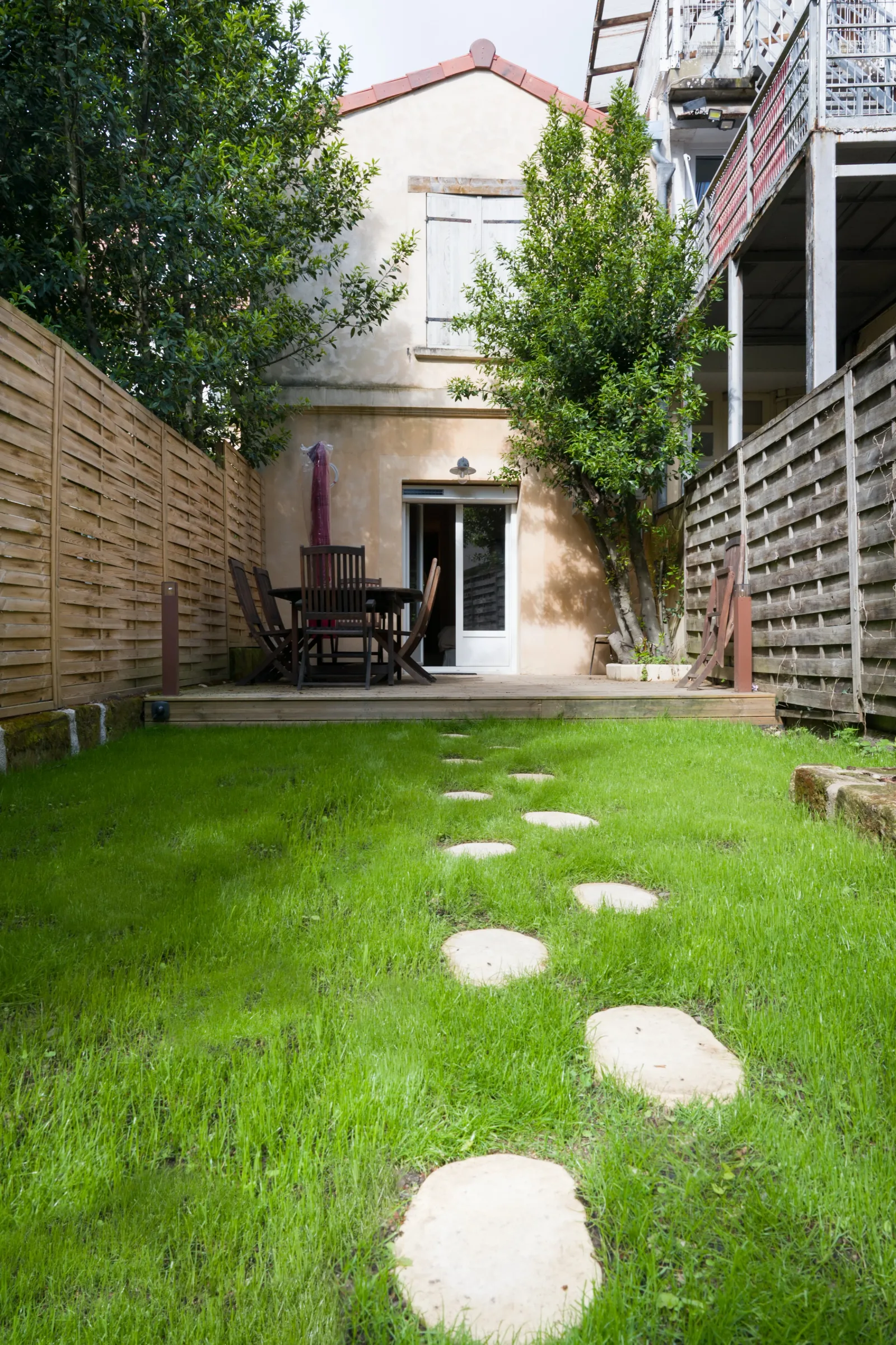 Vue d'ensemble du jardin clos avec les deux terrasses de part et d'autre